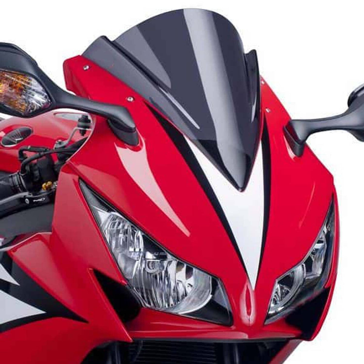 Motorcycle headlight on red sport bike with clear dual lenses and black trim