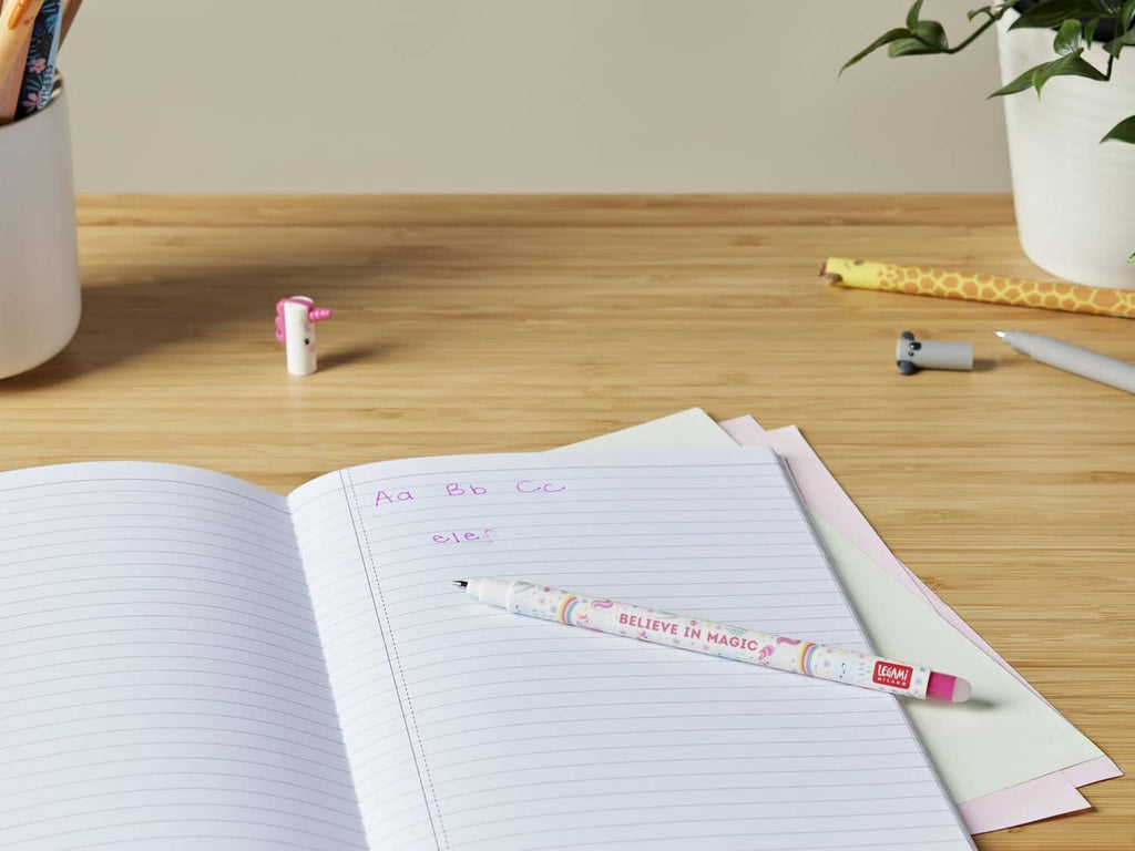 Unicorn erasable gel pen with colorful barrel print and pink tip on lined paper