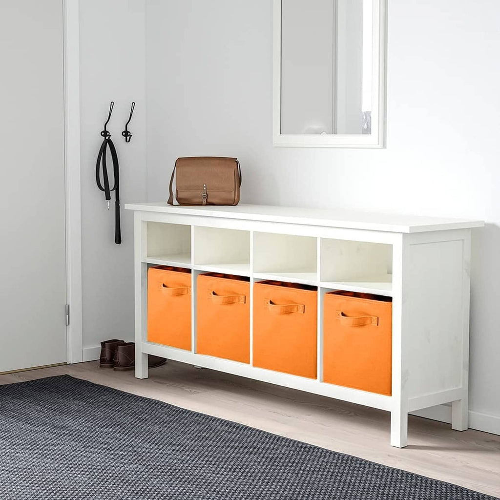 Orange fabric storage cubes in a white cabinet, front handle cutouts visible