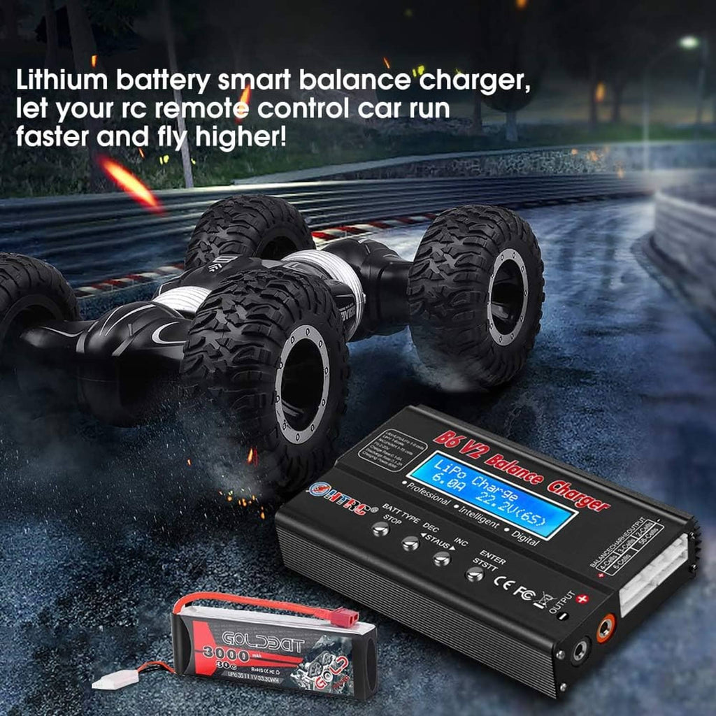 RC balance charger near remote control car wheels and a battery pack, black unit