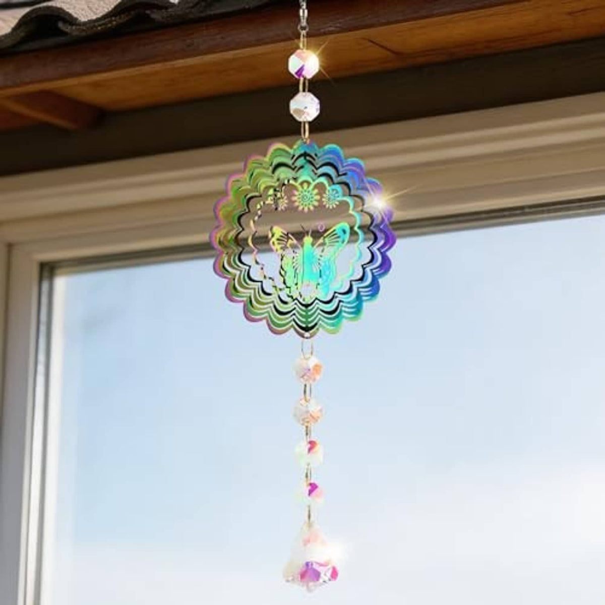 Butterfly crystal wind spinner suncatcher hanging from window beam with multicolor beads