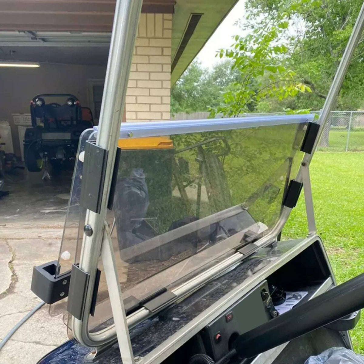 Tinted windshield windscreen panel with metal posts, rail, and mounting clamps