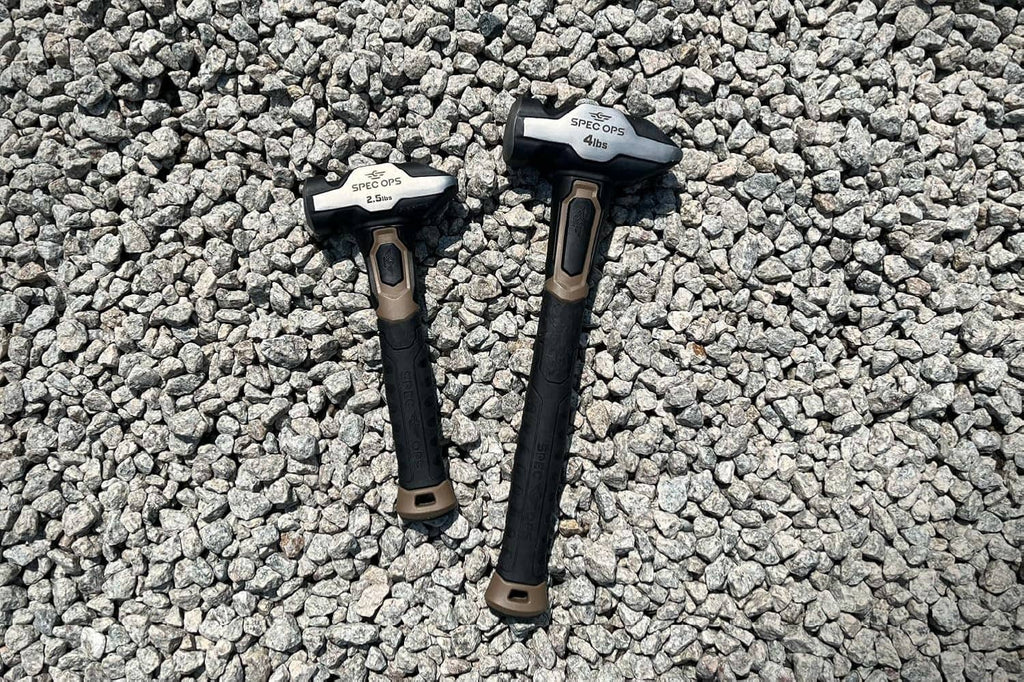 Two blacksmith hammers with dark handles and light head markings