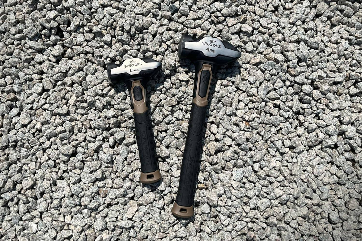 Two blacksmith hammers with dark handles and light head markings