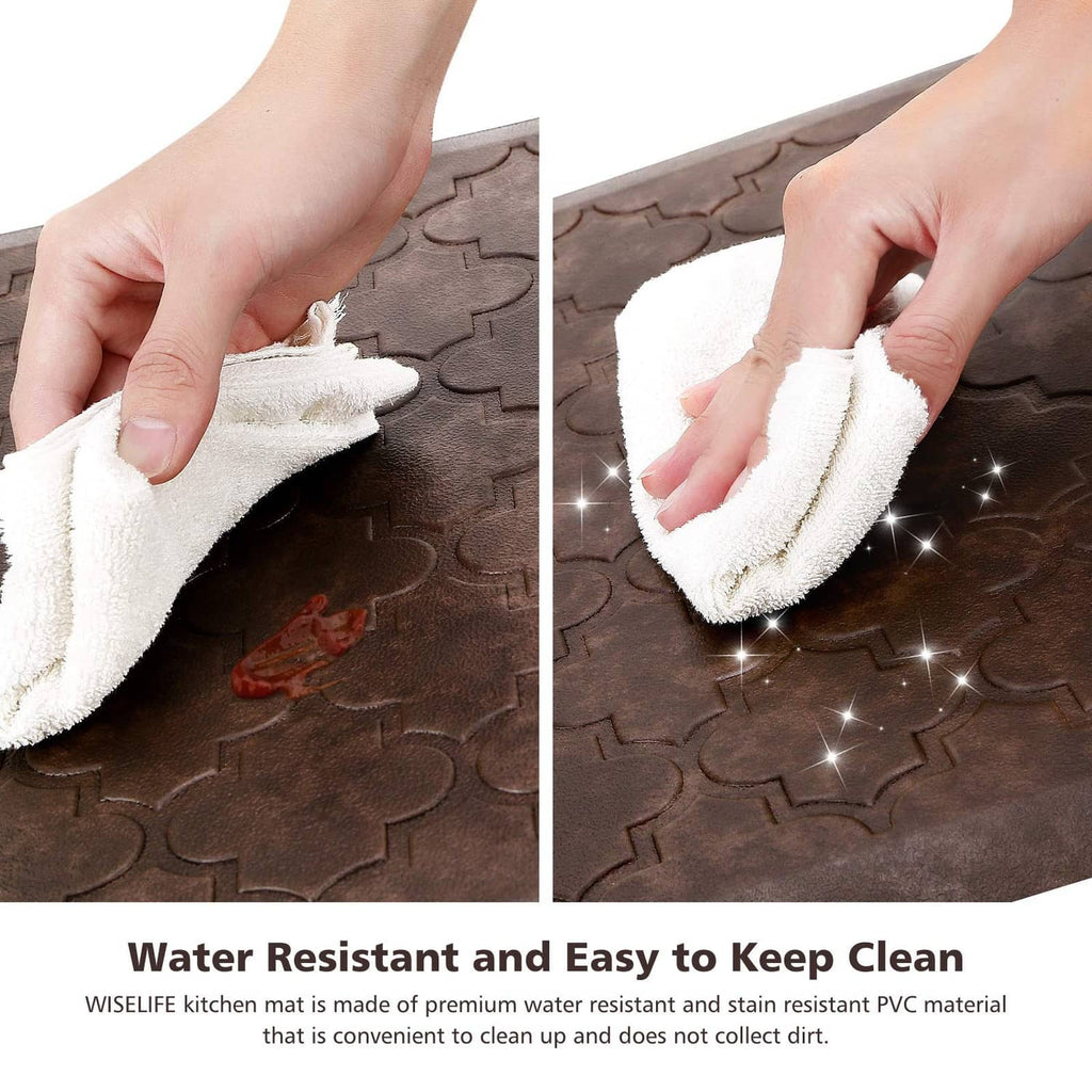 Brown kitchen floor mat being wiped clean on embossed clover surface