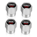 Silver metal tire valve stem caps with Audi logo on black inset