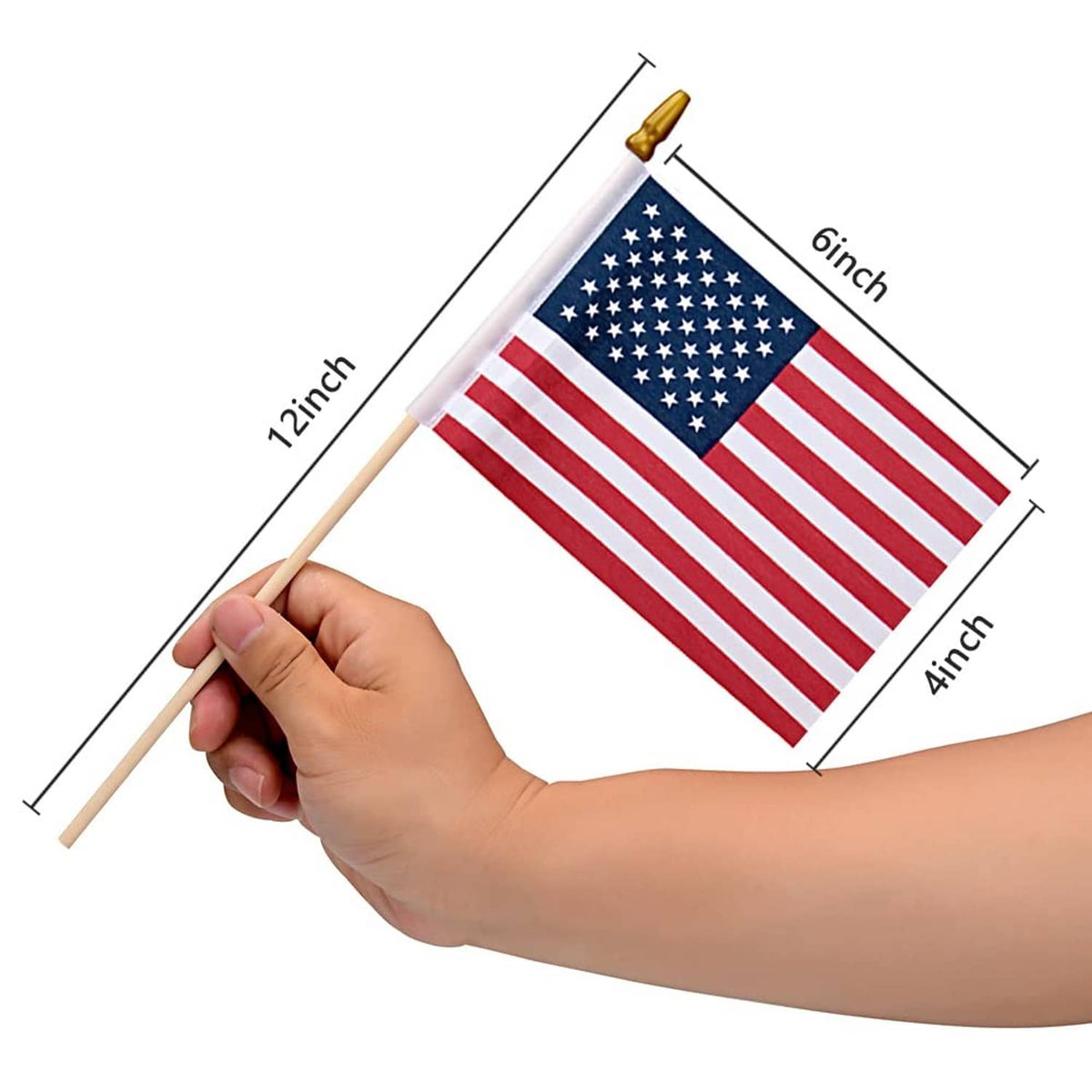 Small US flag on wooden stick held in hand, red stripes and blue star field