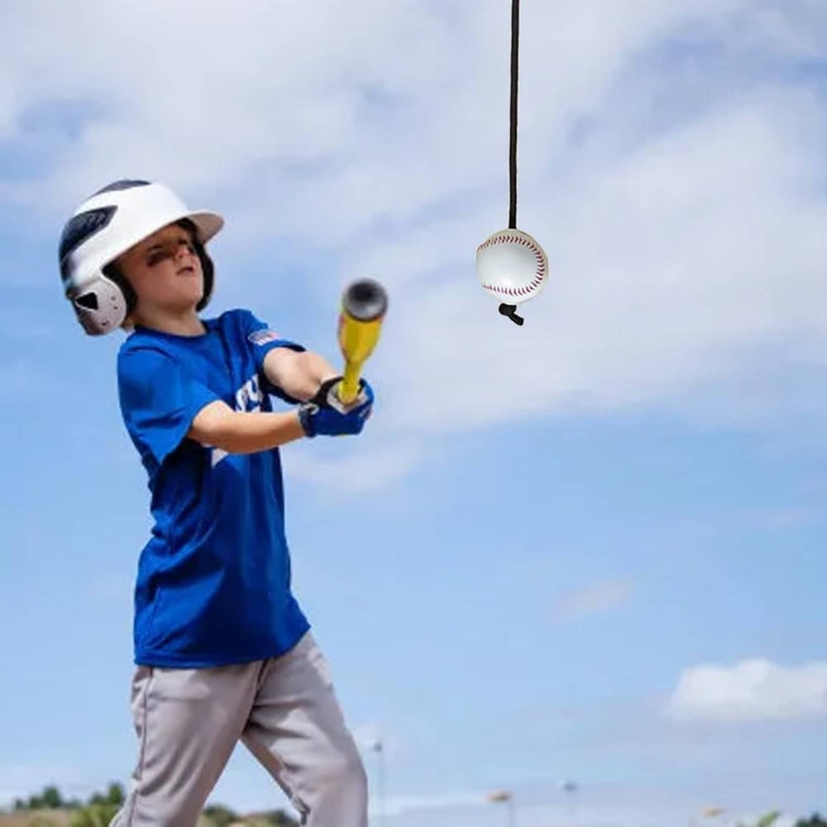 Youth baseball training tether ball attached to cord, ball hanging overhead