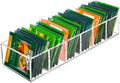 Clear acrylic tea bag organizer with angled slots holding multiple green and orange packets