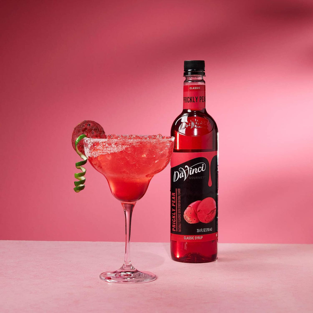 DaVinci Gourmet prickly pear syrup bottle with cocktail and prickly pear fruit
