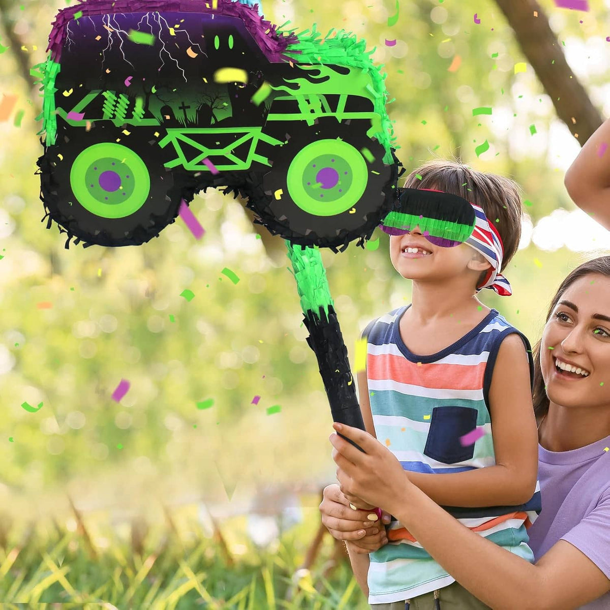 Green and purple monster truck piñata with stick and blindfold
