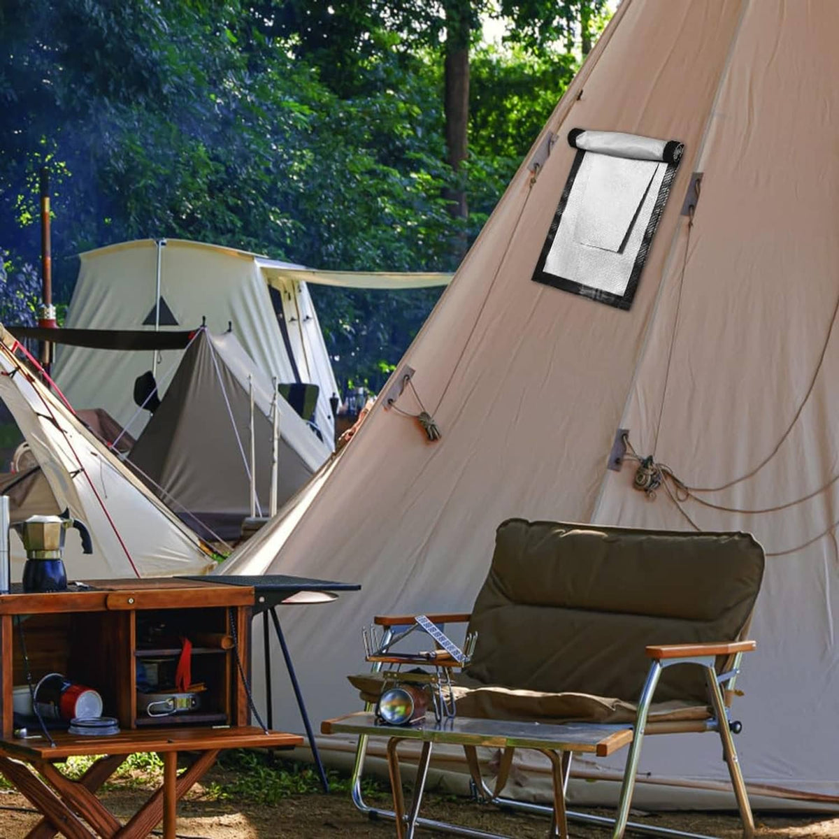 Tent roof stove jack panel with chimney opening near a camping stove and seating