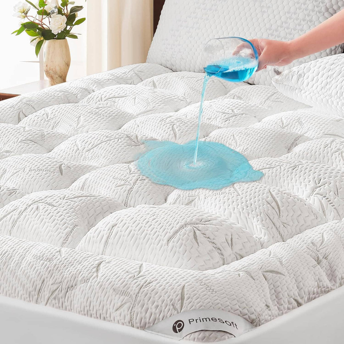 White quilted king-size mattress topper with waterproof blue water puddle