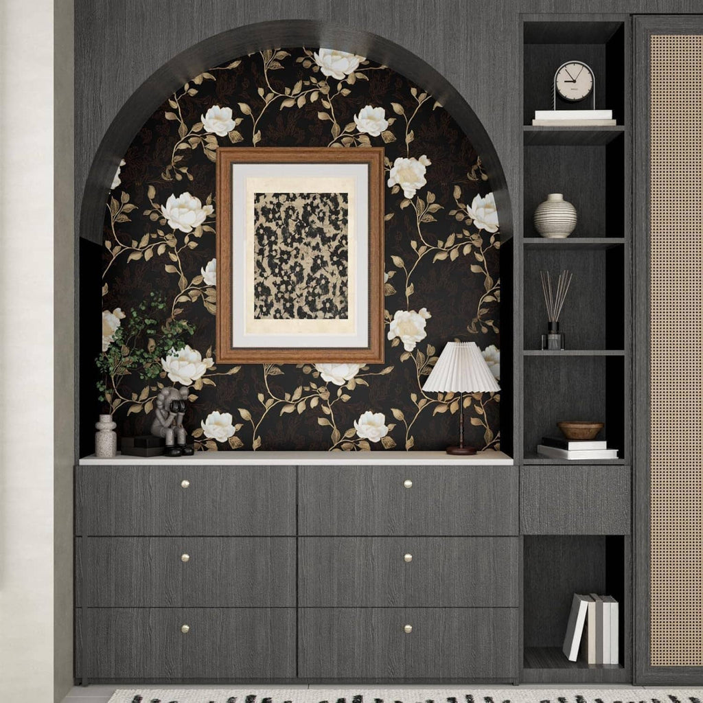 Black floral wallpaper with golden roses and leaves behind wall shelves and drawers