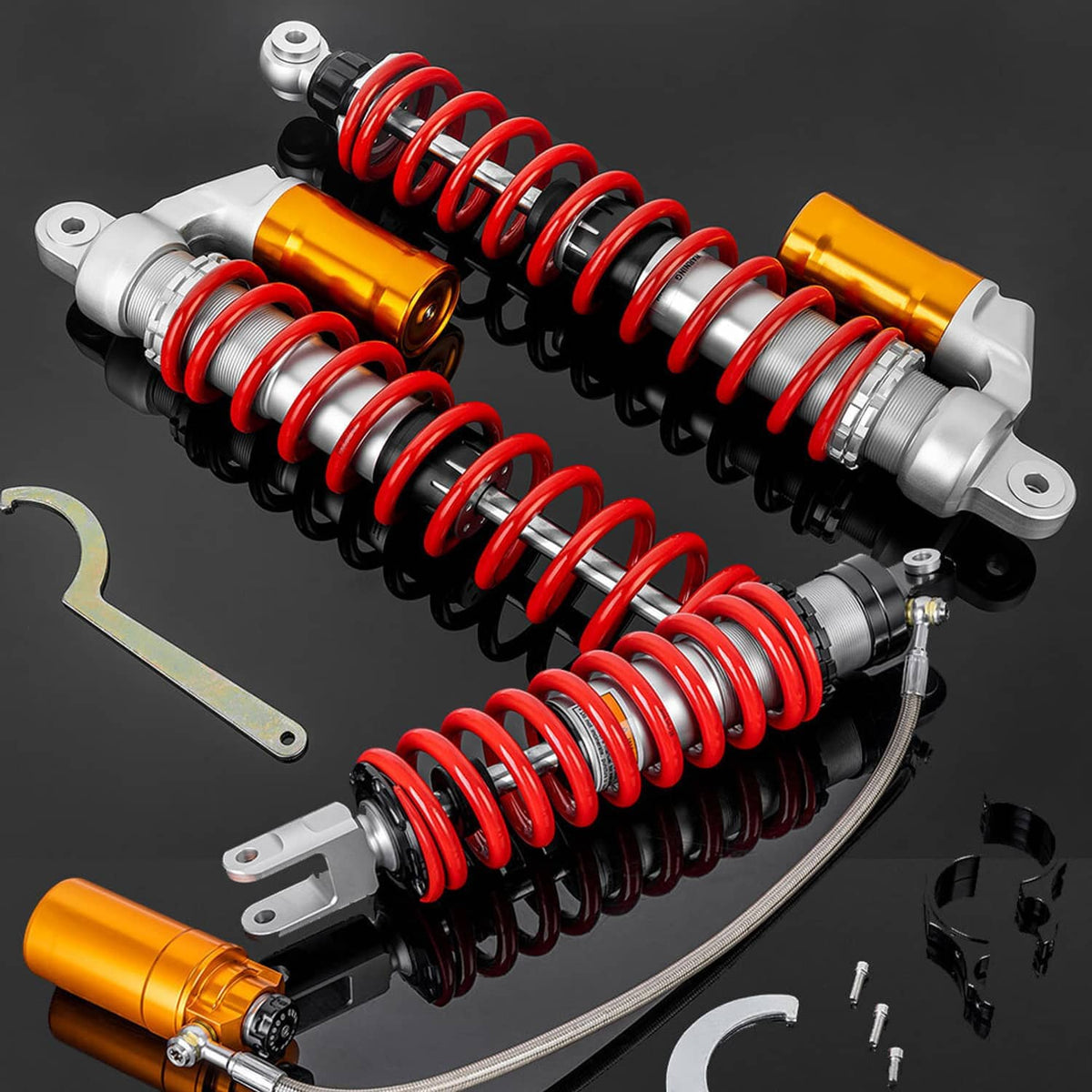 Pair of air shock absorbers with red springs, orange reservoirs, and silver mounts