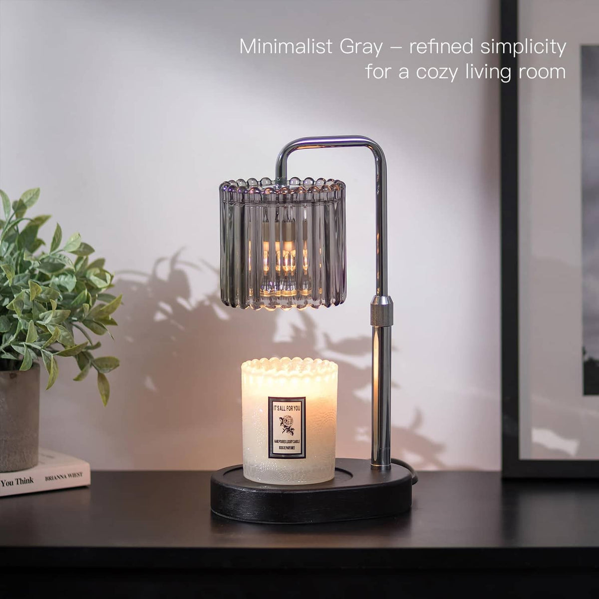 Minimal gray wax melt warmer lamp with clear glass drum and amber candle on black base