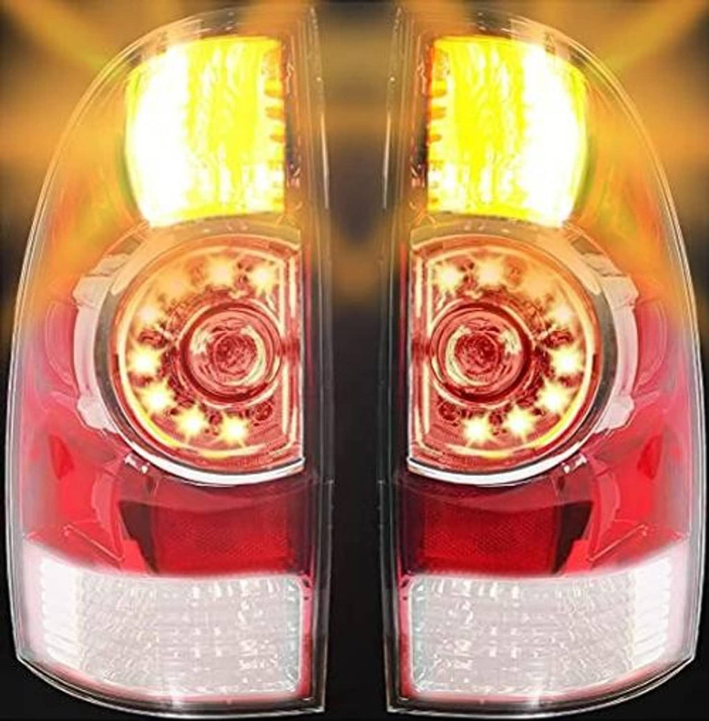 Backlit tail light assembly pair glowing yellow through red and clear lenses