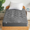 Gray quilted mattress topper with deep channel stitching and finished edges