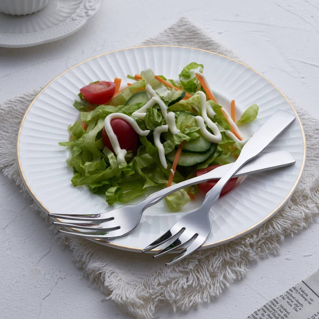 Stainless steel three-tine dinner fork, polished silver head and handle