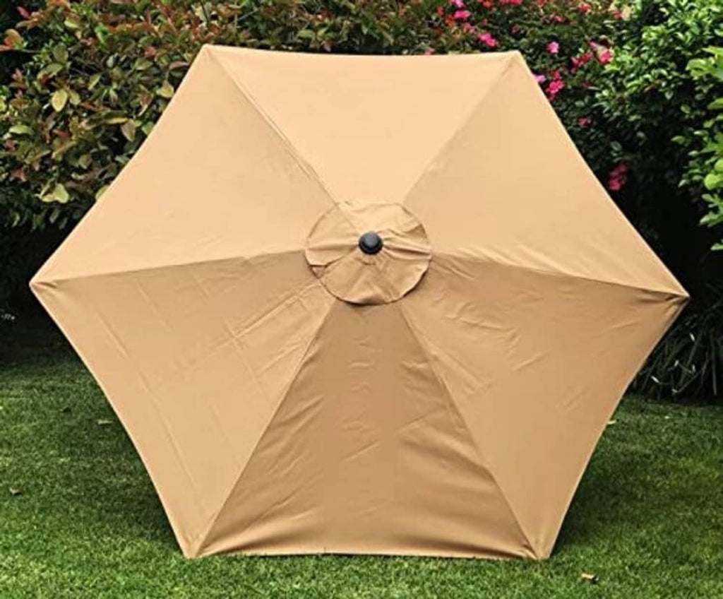 Tan umbrella canopy with central button and crisscross seam panels over ribs.