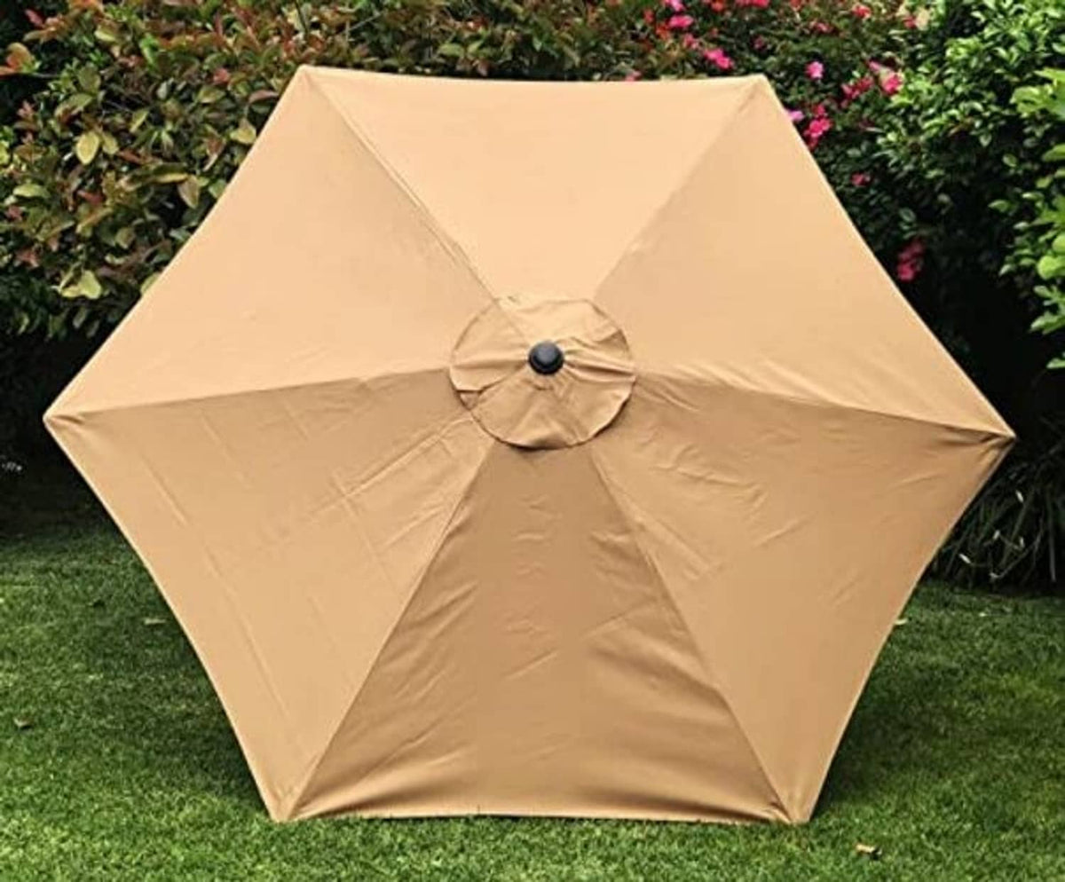 Tan umbrella canopy with central button and crisscross seam panels over ribs.