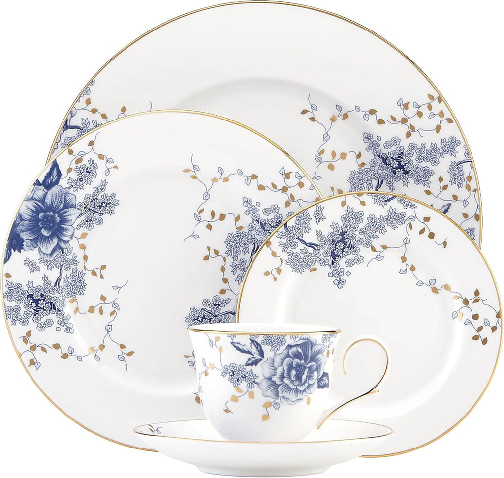Blue floral porcelain dinnerware set with cup, saucer, and plates featuring gold edging