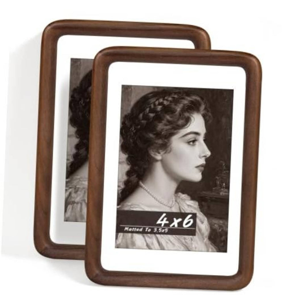 Two walnut wood photo frames with white mats, featuring black-and-white portrait photos