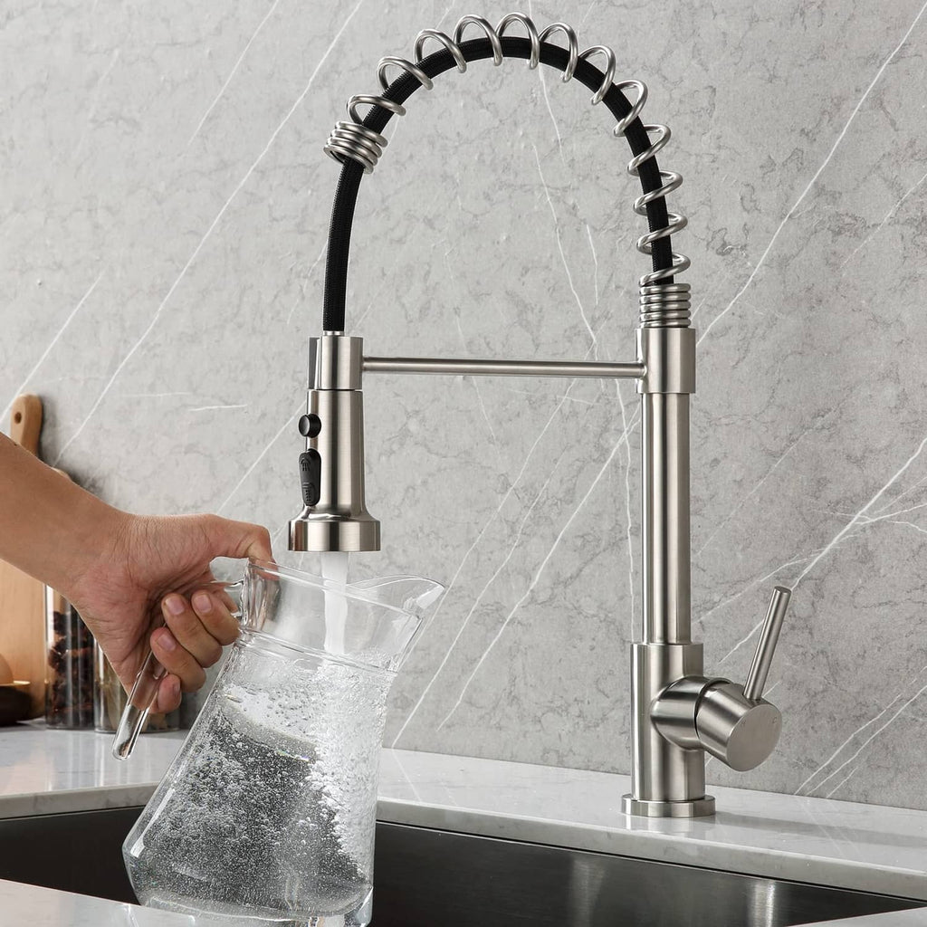 Brushed nickel kitchen faucet sprayer head and hose filling a glass pitcher