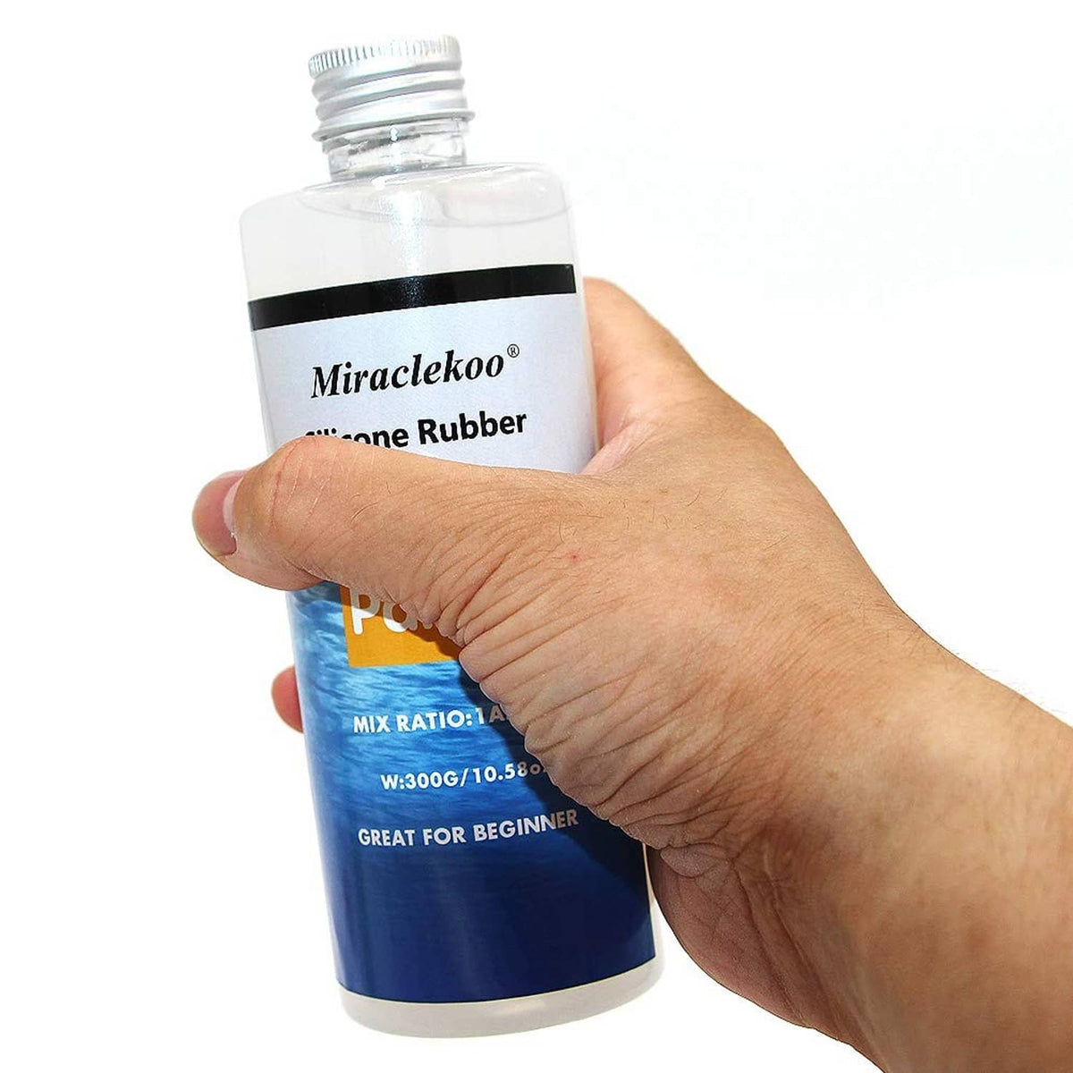 Hand holding silicone rubber Part B bottle in blue, with measuring and mixing info