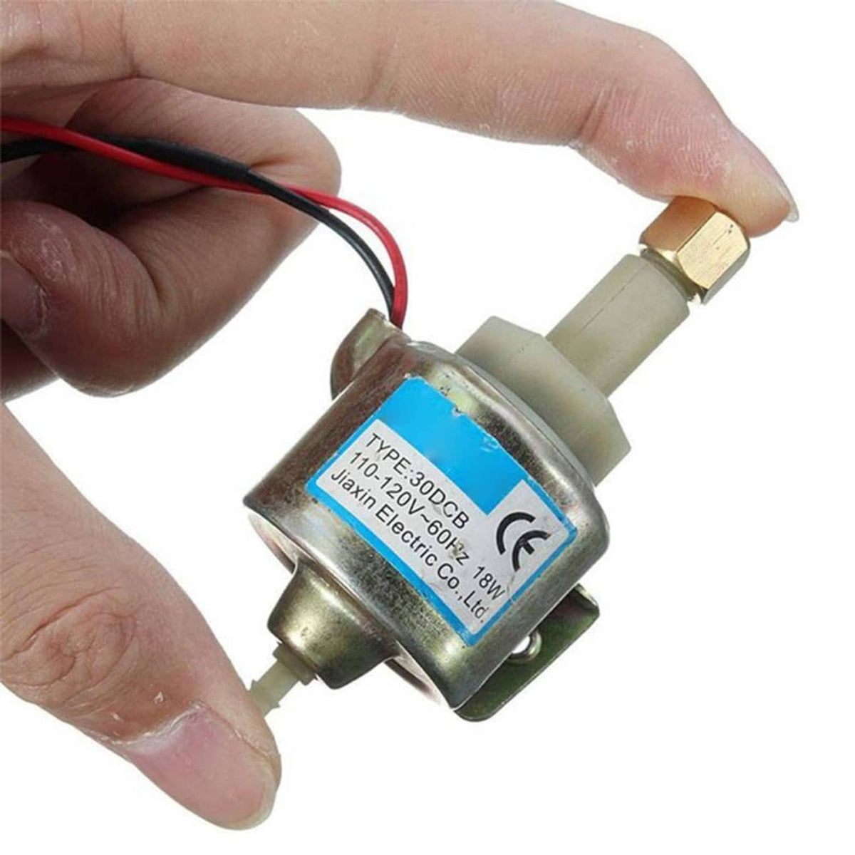 Close-up of smoke machine oil pump with blue rating label and red/black wires