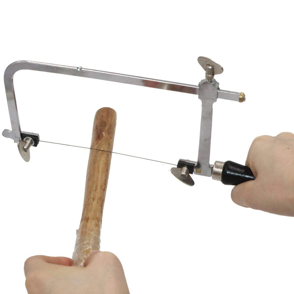 Jeweler's saw frame cutting wood with tensioned blade and black grip handle