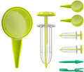 Green handheld seed dispenser set with clear tube, dial, nozzles, and end caps