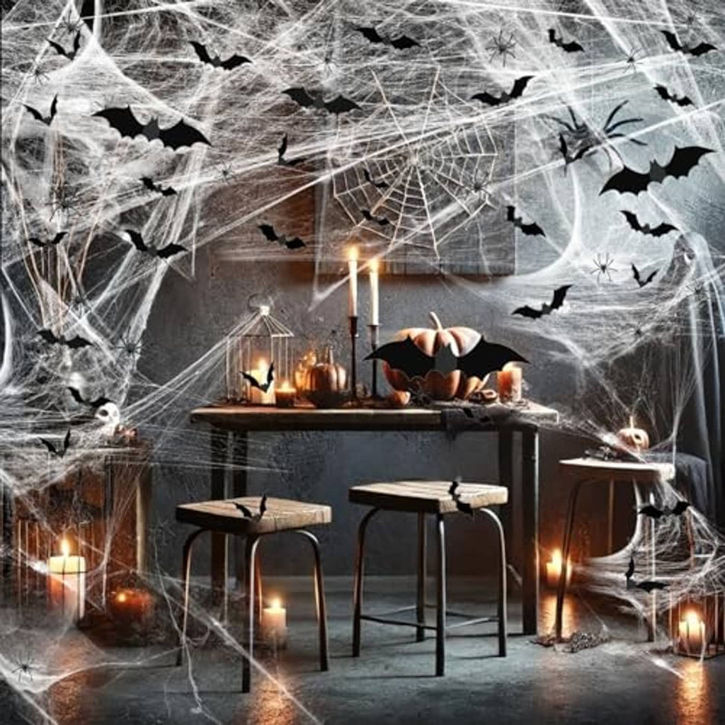 Halloween spider web decoration draped over a table with candles and pumpkins