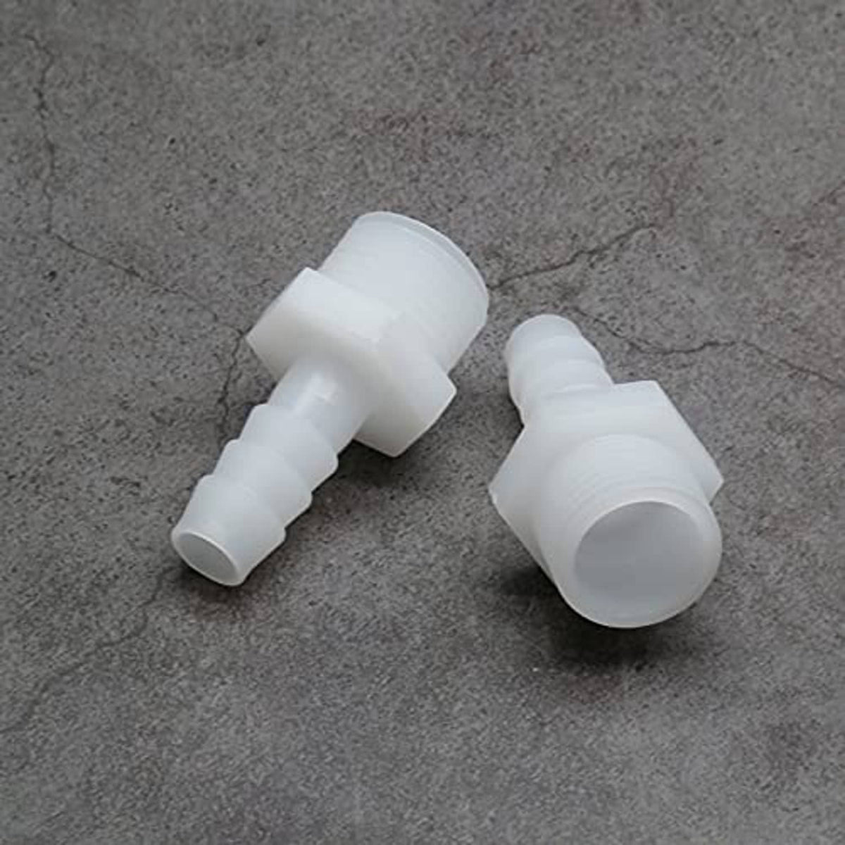 Two plastic hose barb adapters with barbed ends and 1/2 in NPT male threads