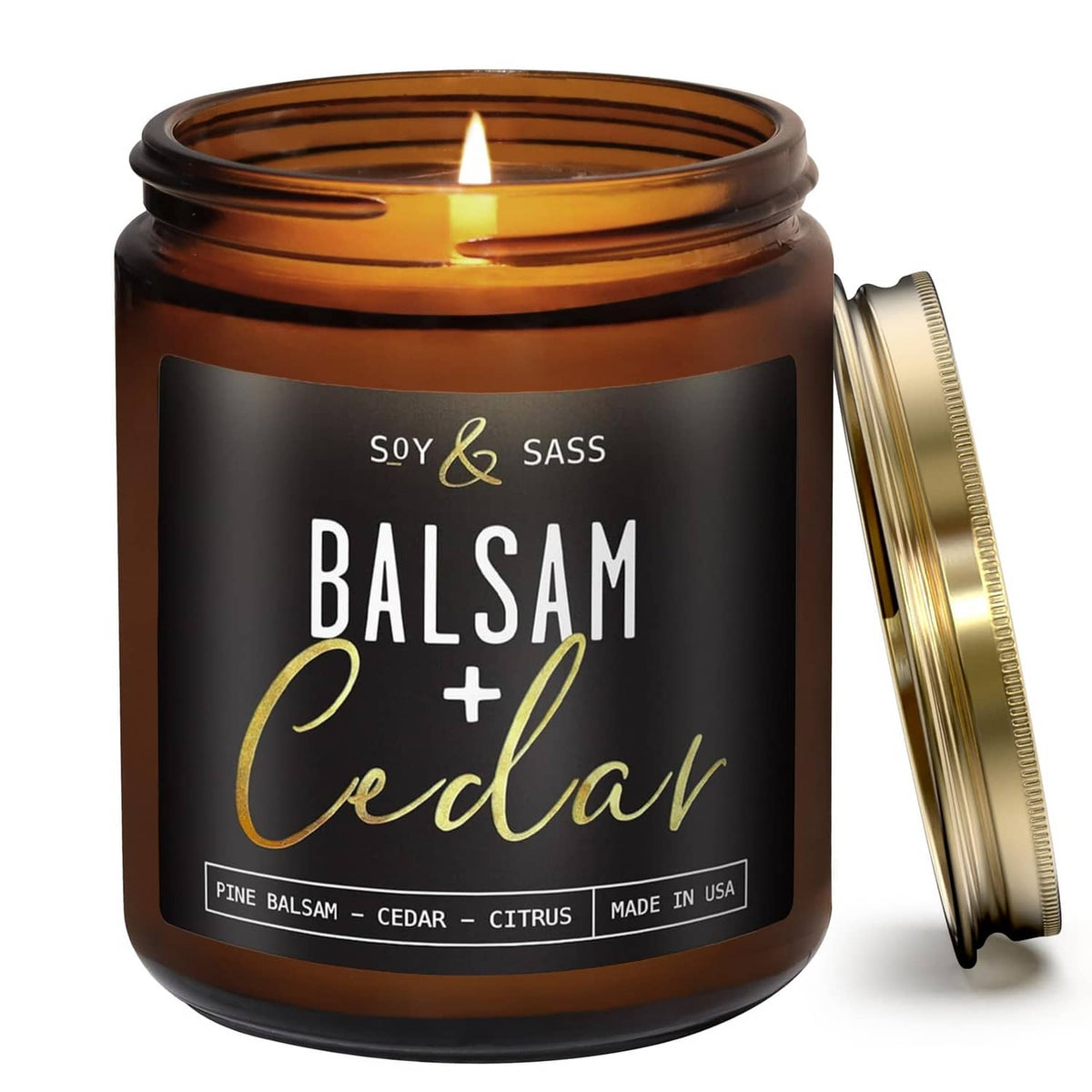 Amber glass soy candle jar with gold lid open and small flame