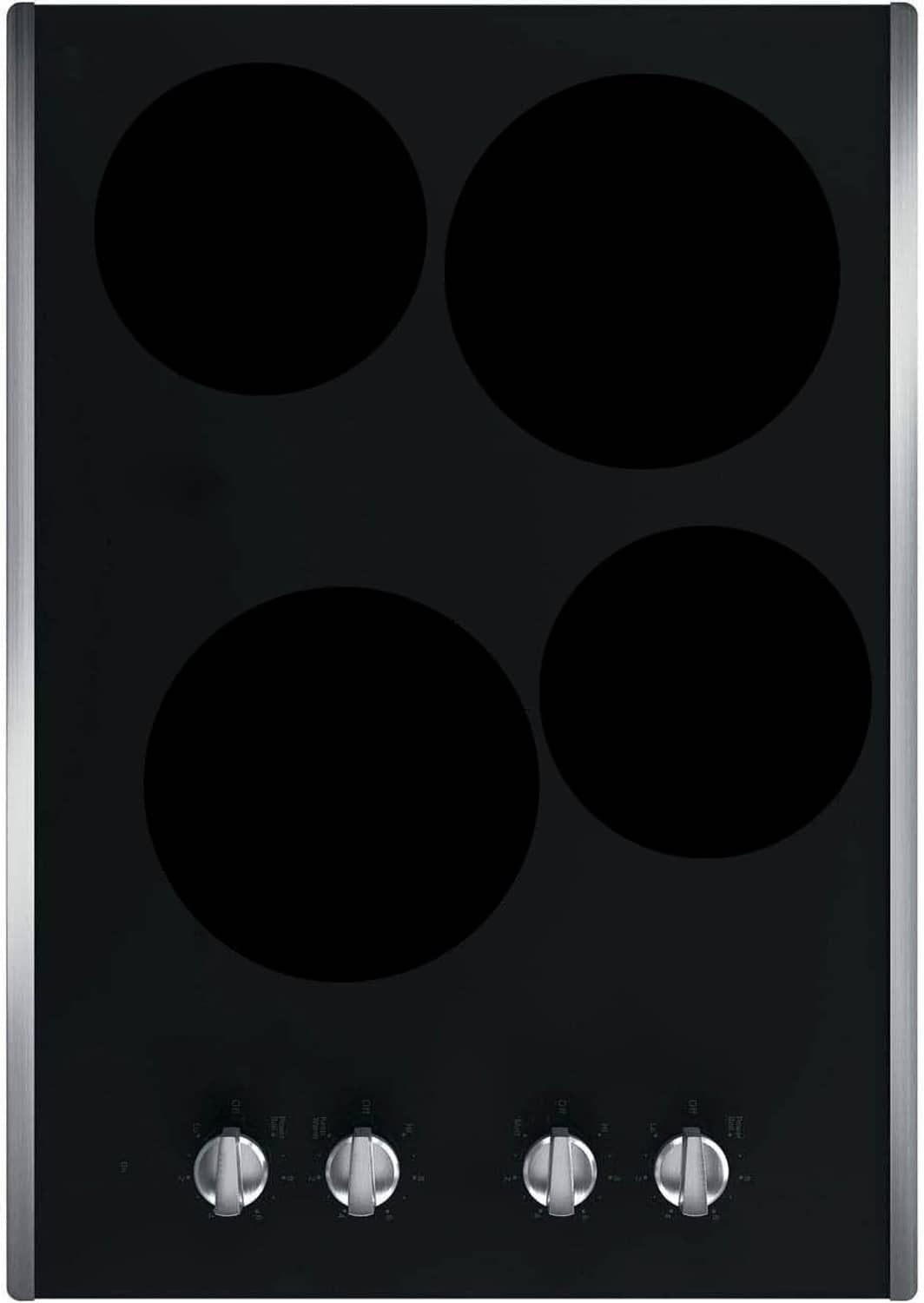 Black electric stove burner covers with four circular openings and control knobs