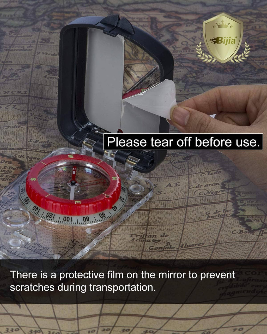 Orienteering compass with red dial and sighting mirror, protective film on mirror