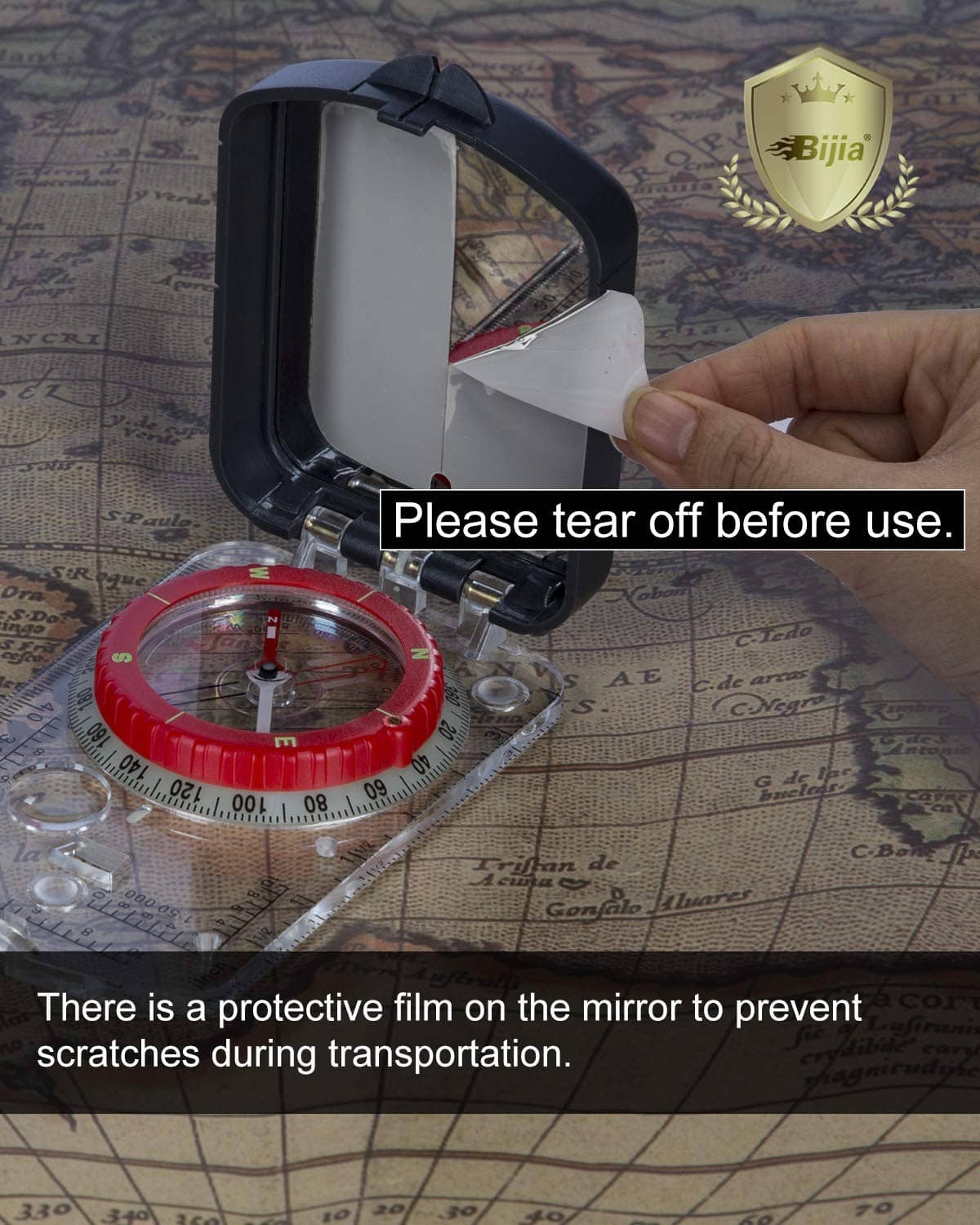 Orienteering compass with red dial and sighting mirror, protective film on mirror