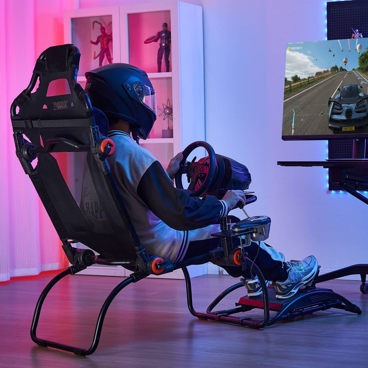 Racing simulator wheel stand setup with steering wheel and pedals on the black frame