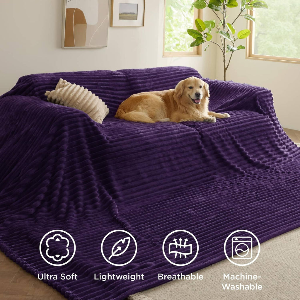 Purple fleece blanket spread on bed with plush ridged surface