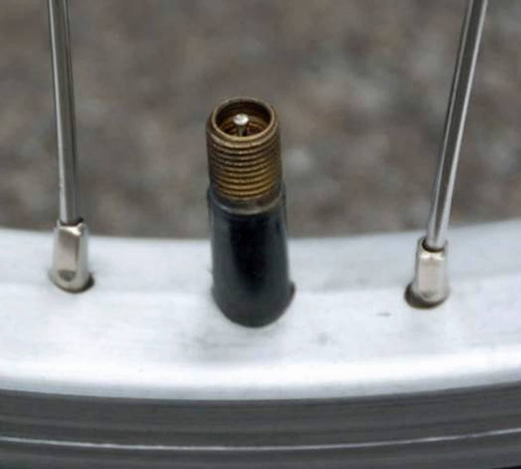 Black bicycle inner tube valve stem with threaded end, ready to inflate