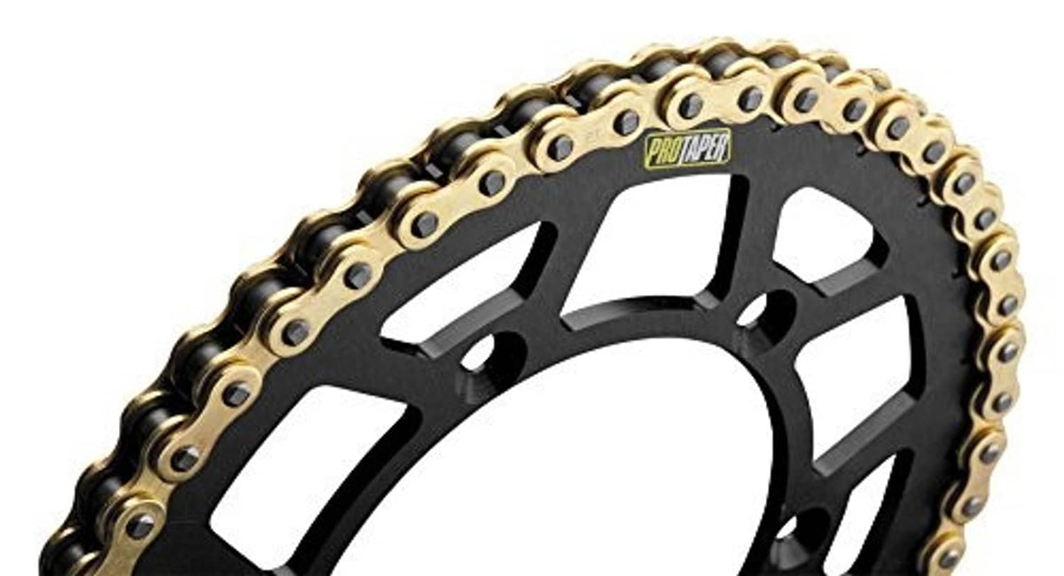 Gold motorcycle chain with black sprocket wheel, close-up detail