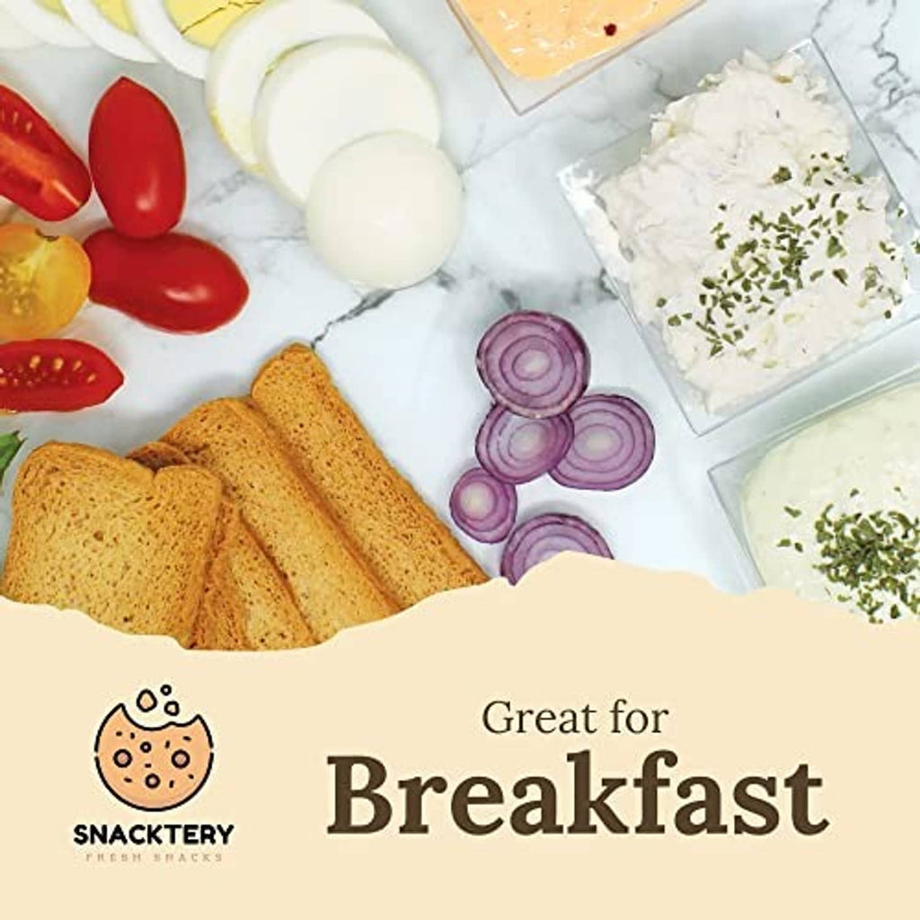 Thin crispy melba toast crackers with sliced cheese, tomatoes, and red onions