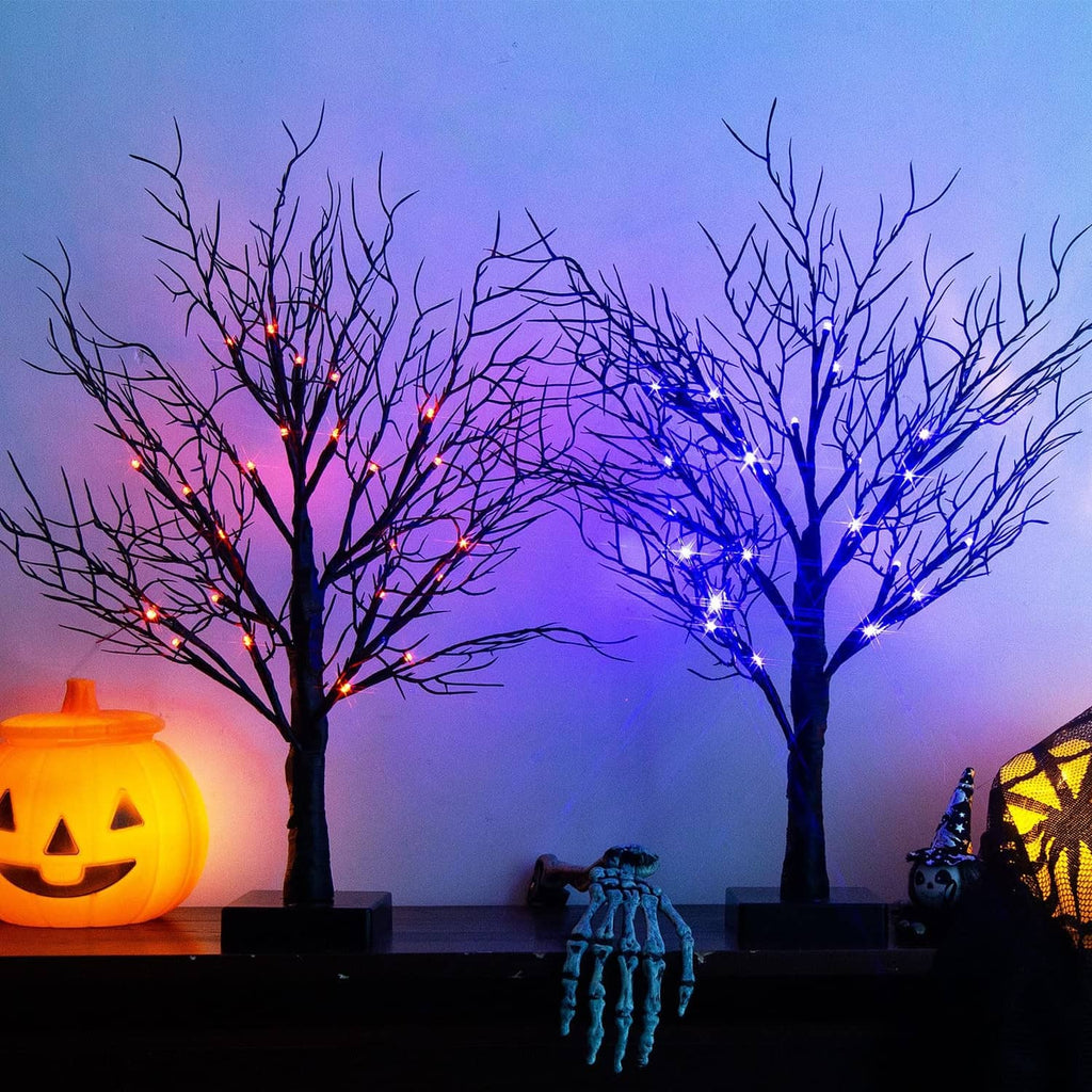 Two lighted Halloween decorative trees with purple and orange LED lights, black bases