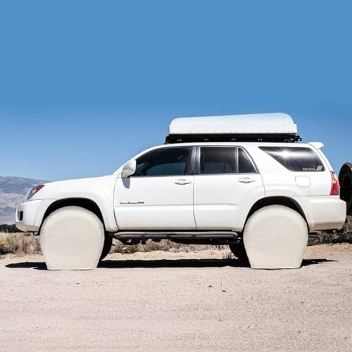 Off-white tire covers on an SUV, rounded wheel protector covers