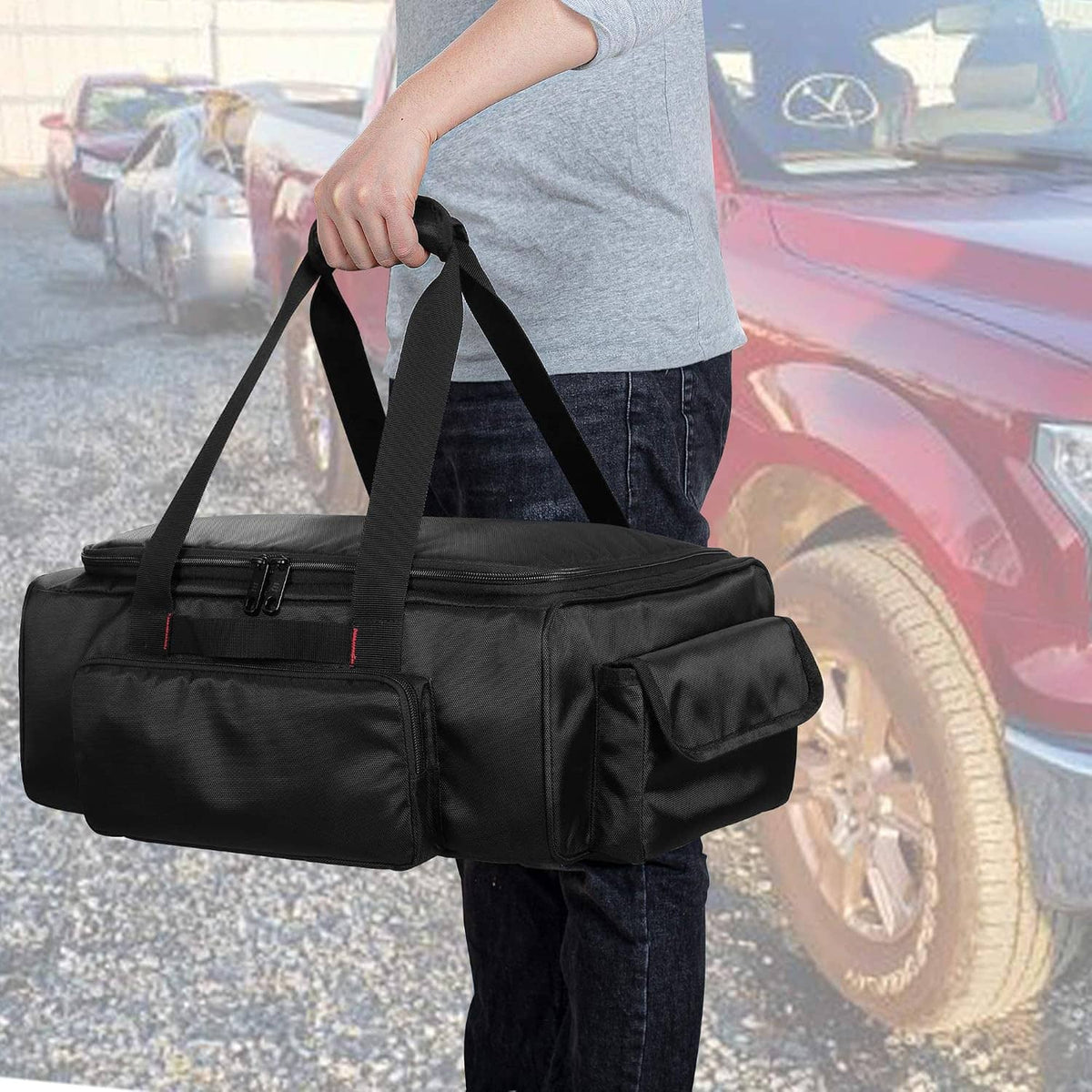 Black under-seat storage bag held by dual top handles with zippered front