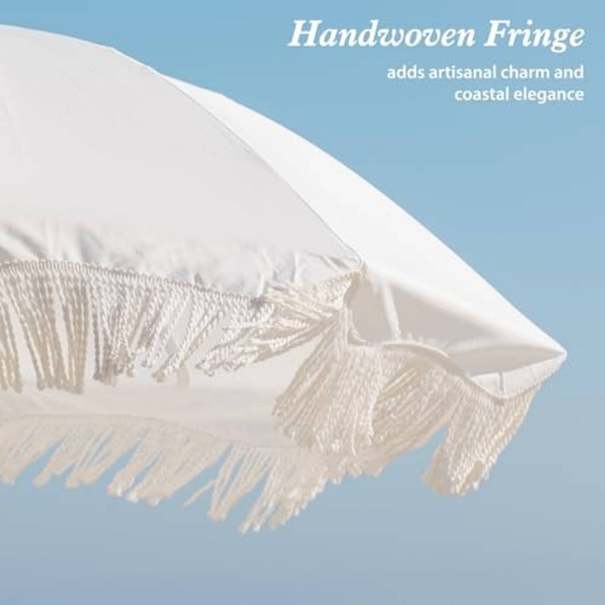 Outdoor patio umbrella canopy edge with white fringe tassels and layered fabric seam.
