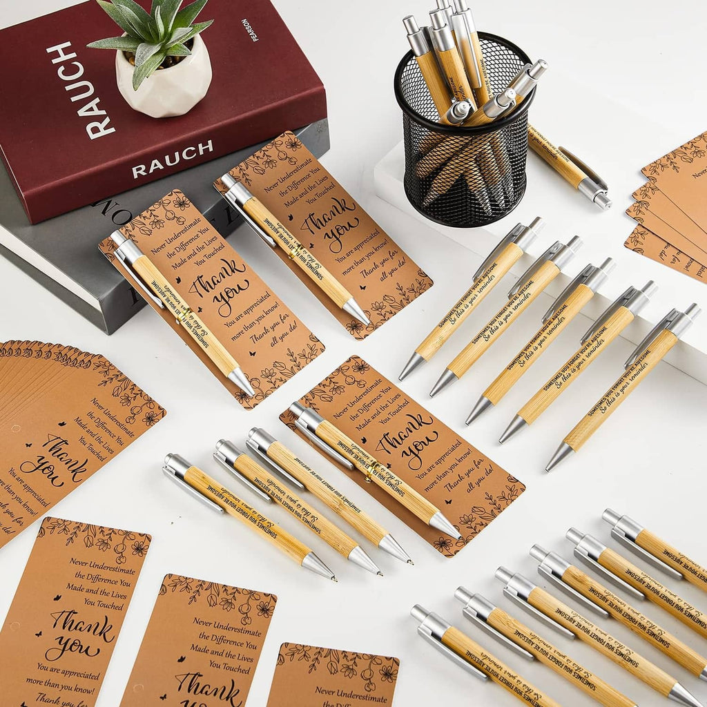 Bulk set of brown “Thank You” pens and cards with metallic cap, assorted on surface