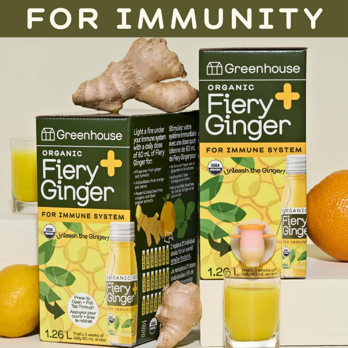 Organic fiery ginger immunity shot boxes with ginger root, lemon, and glass of yellow shot
