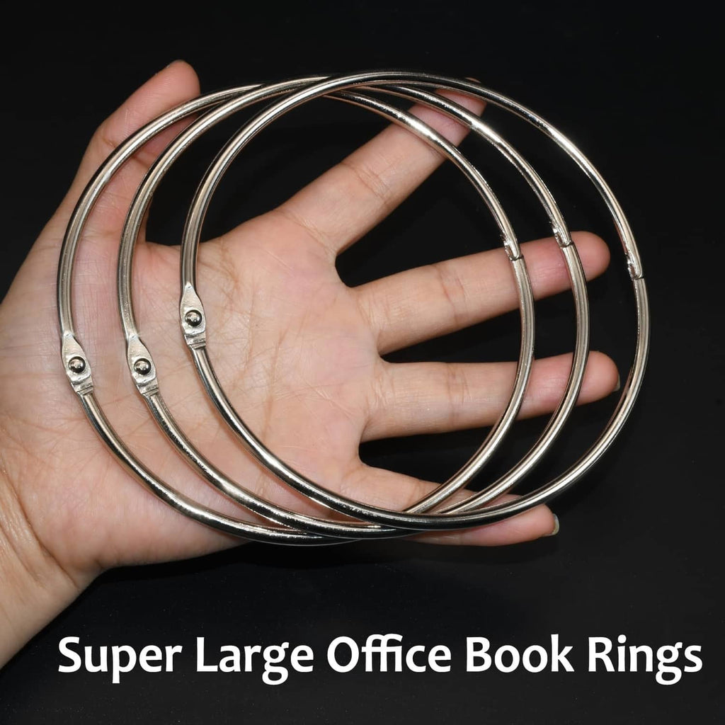 Extra-large nickel-plated silver binder rings held in hand, 4.5-inch loops